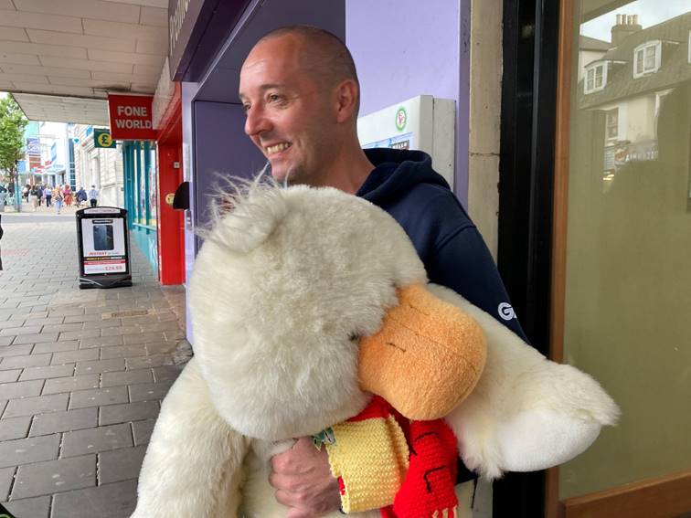 A person holding a large stuffed animal

Description automatically generated with medium confidence