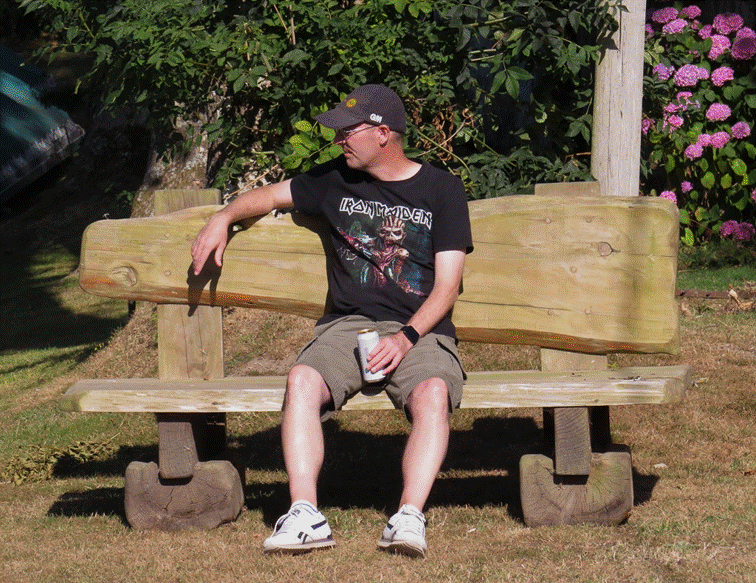 A person sitting on a bench

Description automatically generated