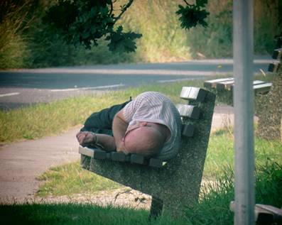 A person lying on a bench

Description automatically generated with low confidence