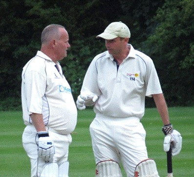 A couple of men in white sports uniforms

Description automatically generated